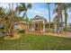 Inviting coastal home with a spacious front porch and lush landscaping at 306 55Th St, Holmes Beach, FL 34217