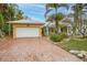 White garage door and brick driveway offering ample parking at 306 55Th St, Holmes Beach, FL 34217