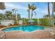 Inviting kidney-shaped pool with brick patio and lush landscaping at 306 55Th St, Holmes Beach, FL 34217