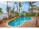 Inviting kidney-shaped pool with brick patio and lush landscaping at 306 55Th St, Holmes Beach, FL 34217