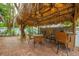 Outdoor tiki hut with seating and ceiling fans at 306 55Th St, Holmes Beach, FL 34217