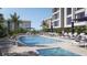 Resort-style pool and lounge area at a modern condo building, perfect for relaxation at 325 Golden Gate Pt # 301, Sarasota, FL 34236