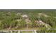 Expansive aerial view of a wooded property with various structures and a long driveway at 3340 Ulman Ave, North Port, FL 34286