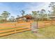 Rustic barn with open-air stalls and wooden fencing at 3340 Ulman Ave, North Port, FL 34286