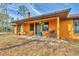 Inviting front porch with a green door and wooden rocking chairs at 3340 Ulman Ave, North Port, FL 34286