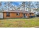 Ranch style home with orange exterior and fenced backyard at 3340 Ulman Ave, North Port, FL 34286