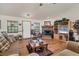 Cozy living room featuring a brick fireplace, comfortable seating, and wood-look floors at 3340 Ulman Ave, North Port, FL 34286