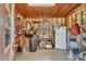 Functional tack room with wood-paneled walls, storage shelves, mini fridge, and supplies for equestrian needs at 3340 Ulman Ave, North Port, FL 34286