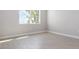 Bright bedroom with large window and wood-look tile floor at 3415 Nadasky Ave, North Port, FL 34288