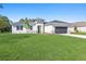 Newly built home with gray roof, stone accents, and a two-car garage at 3415 Nadasky Ave, North Port, FL 34288