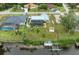 Aerial view of canal-front property with a pool and private dock at 3438 Yukon Dr, Port Charlotte, FL 33948