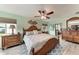 Spacious bedroom with wood furniture and ceiling fan at 3438 Yukon Dr, Port Charlotte, FL 33948