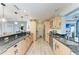 Bright kitchen featuring wood cabinets and granite countertops at 3438 Yukon Dr, Port Charlotte, FL 33948