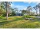 Large backyard with lush lawn and a screened-in lanai at 3501 Sunbeam Dr, Sarasota, FL 34240