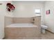 Bright bathroom featuring a tiled tub, neutral walls, and modern fixtures, offering a clean and serene space at 3501 Sunbeam Dr, Sarasota, FL 34240