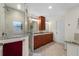 Modern bathroom featuring double sinks, a walk-in shower, and neutral tile flooring at 3501 Sunbeam Dr, Sarasota, FL 34240