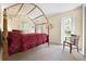 Bright bedroom with a four-poster bed and ample natural light streaming through the windows, creating a serene ambiance at 3501 Sunbeam Dr, Sarasota, FL 34240