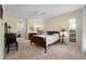 Cozy bedroom with plush carpeting, a ceiling fan, and ample natural light streaming through the window at 3501 Sunbeam Dr, Sarasota, FL 34240