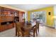 Bright dining room with glass front display cabinets, room for four, and view to the pool at 3501 Sunbeam Dr, Sarasota, FL 34240