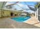 Inviting screened-in pool with tile deck, outdoor seating, and lush landscaping at 3501 Sunbeam Dr, Sarasota, FL 34240