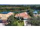 Single-Gathering home with lake view, showcasing backyard and landscaping at 3716 Eagle Hammock Dr, Sarasota, FL 34240