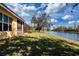 Home's backyard features a canal-side view and lush grass at 3716 Eagle Hammock Dr, Sarasota, FL 34240