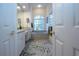 Elegant bathroom with double vanity, soaking tub, and patterned rug at 3716 Eagle Hammock Dr, Sarasota, FL 34240