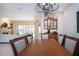 Bright dining room with hardwood table and view into Gathering room at 3716 Eagle Hammock Dr, Sarasota, FL 34240