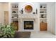 Elegant fireplace with built-in shelving and decorative accents at 3716 Eagle Hammock Dr, Sarasota, FL 34240