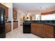 Modern kitchen featuring wood cabinets, granite countertops, and a large island at 3716 Eagle Hammock Dr, Sarasota, FL 34240