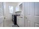 Convenient laundry room with washer, dryer, and cabinets at 3716 Eagle Hammock Dr, Sarasota, FL 34240