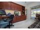 Home office with built-in desk and access to a lanai at 3716 Eagle Hammock Dr, Sarasota, FL 34240