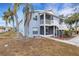 Light blue two-story condo with balcony, screened porch, and palm trees at 3815 59Th W Ave # 3815, Bradenton, FL 34210