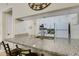 Granite kitchen counter with breakfast bar and view into living area at 3815 59Th W Ave # 3815, Bradenton, FL 34210