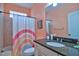 Bathroom with rainbow shower curtain and granite countertop at 3906 Chaucer Ln, Sarasota, FL 34241