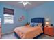 Bedroom with orange bedding, blue headboard, and a coral chair at 3906 Chaucer Ln, Sarasota, FL 34241