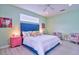 Main bedroom with a blue upholstered bed and pink accents at 3906 Chaucer Ln, Sarasota, FL 34241