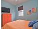 Bedroom with orange bedding, a flat screen TV and orange dresser at 3906 Chaucer Ln, Sarasota, FL 34241