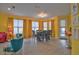 Dining area with a teal table and gray woven chairs at 3906 Chaucer Ln, Sarasota, FL 34241