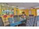 Dining area with teal table and gray woven chairs at 3906 Chaucer Ln, Sarasota, FL 34241