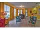 Dining area with floral chairs and a view of the pool at 3906 Chaucer Ln, Sarasota, FL 34241