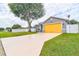 Gray house with a yellow garage door and a long driveway at 3906 Chaucer Ln, Sarasota, FL 34241