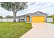 Gray house with a yellow garage door and a well-maintained lawn at 3906 Chaucer Ln, Sarasota, FL 34241