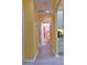 Light yellow hallway with vinyl flooring leading to bathroom at 3906 Chaucer Ln, Sarasota, FL 34241