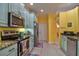 Bright kitchen with stainless steel appliances and light green cabinets at 3906 Chaucer Ln, Sarasota, FL 34241