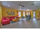 Bright living room with red couch and colorful armchairs at 3906 Chaucer Ln, Sarasota, FL 34241