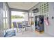 Screened porch with table and chairs, and a mini-fridge at 3906 Chaucer Ln, Sarasota, FL 34241