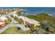 Aerial view of the townhomes highlighting private parking, lush greenery, and beautiful coastal views at 4009 Catalina Dr # 178, Bradenton, FL 34210