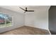 Bright bedroom with wood-look floors and large window at 4009 Catalina Dr # 178, Bradenton, FL 34210