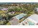 An aerial view of a light blue house with a pool and parking area at 401 Shore Rd, Nokomis, FL 34275